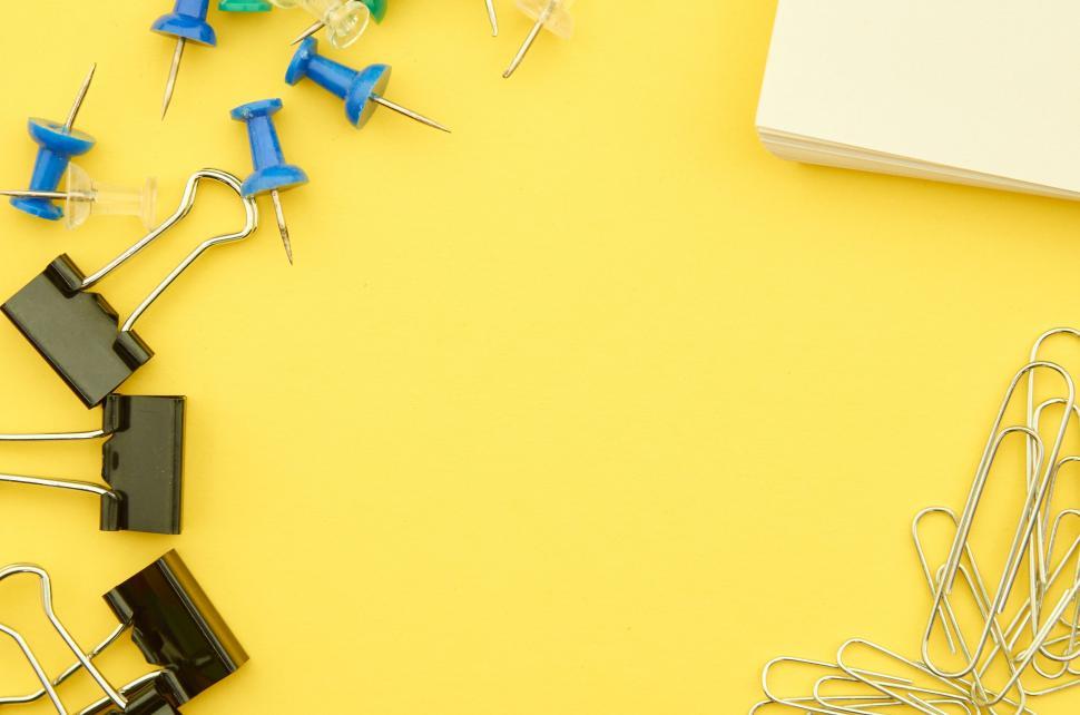 Free Image of A group of office supplies on a yellow surface 