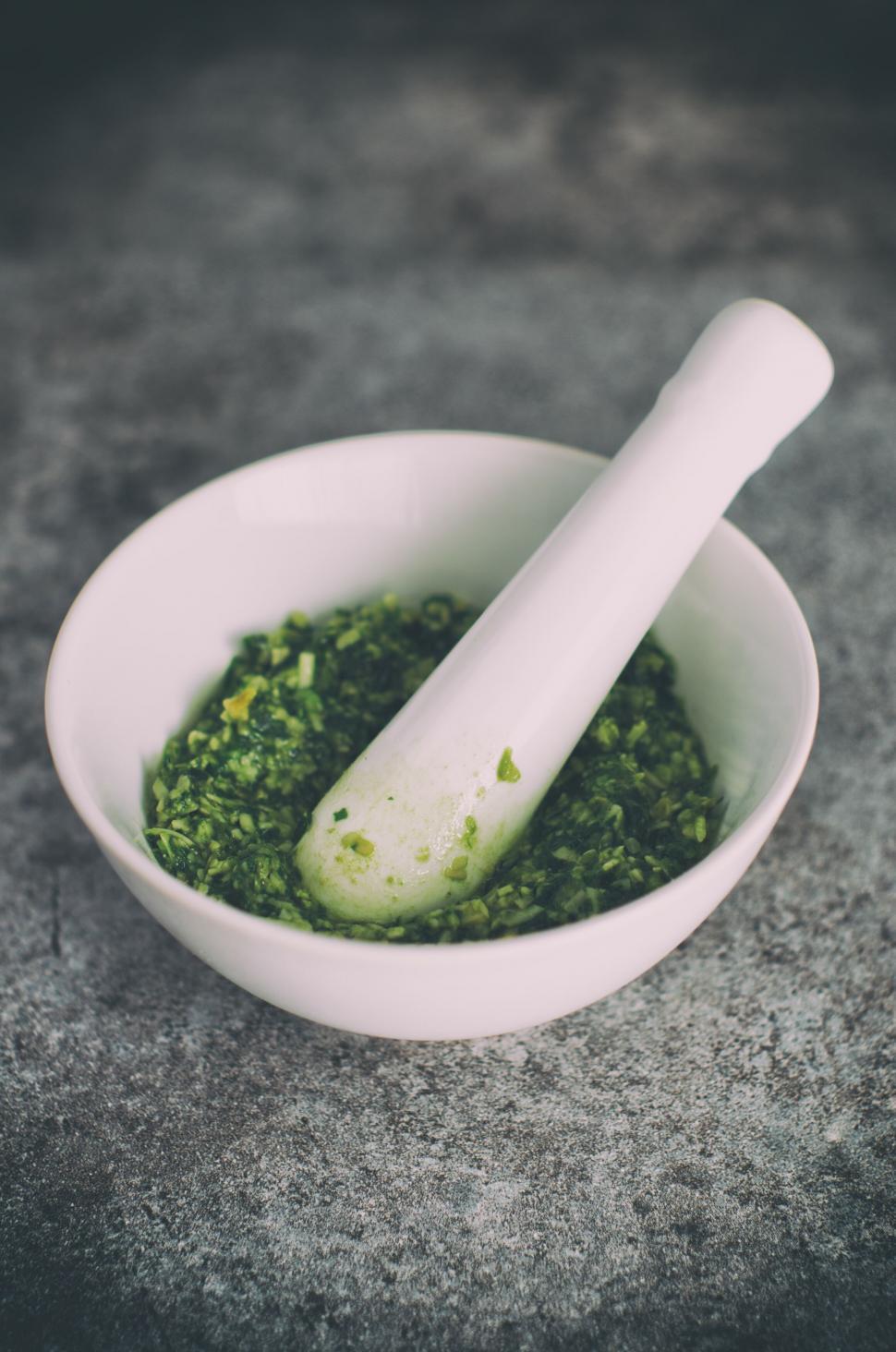 Free Image of A mortar and pestle in a white bowl 