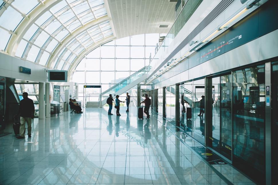 Free Image of People standing in a building with glass windows 