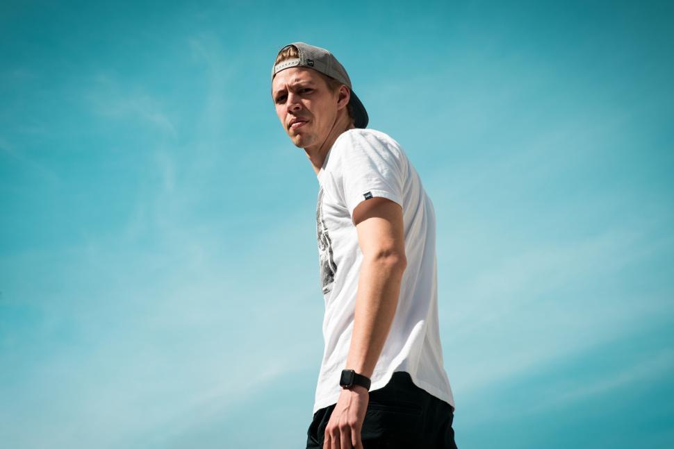 Free Image of A man in a white shirt and cap 