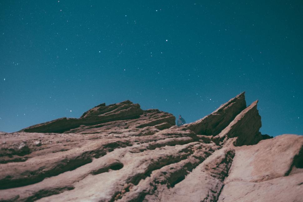 Free Image of A person standing on a rocky mountain 