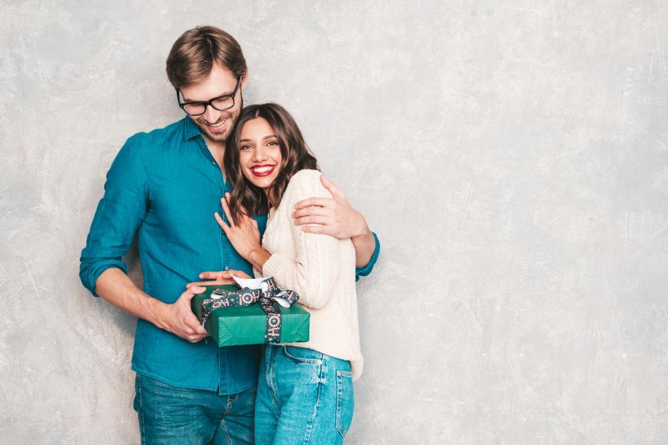 Free Image of A man and woman holding a present 