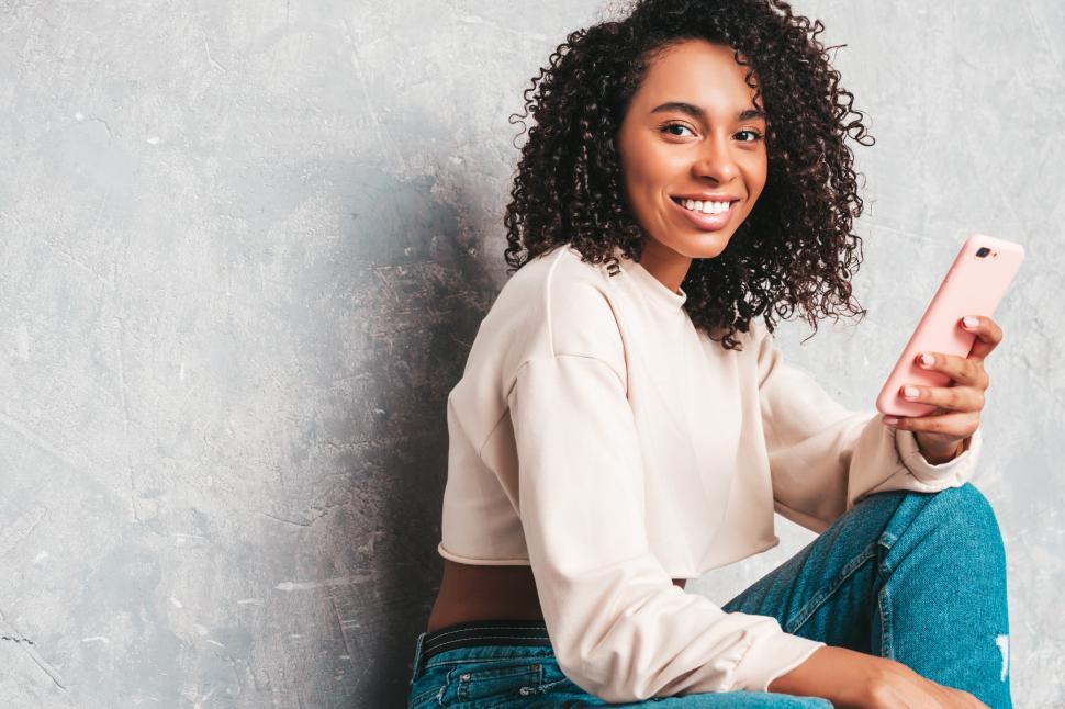Free Image of A woman sitting on the floor 