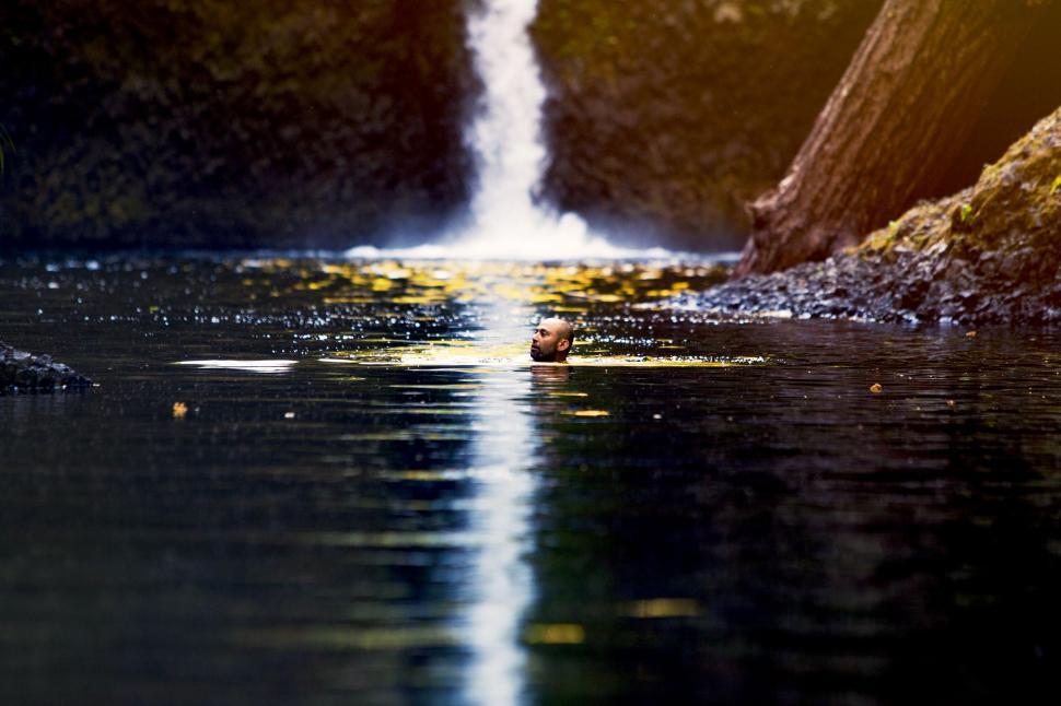 Free Image of A man swimming in a river 