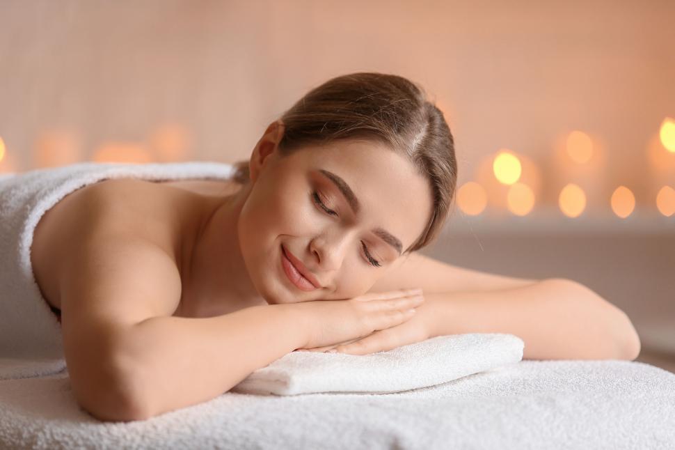 Free Image of A woman lying on a towel 