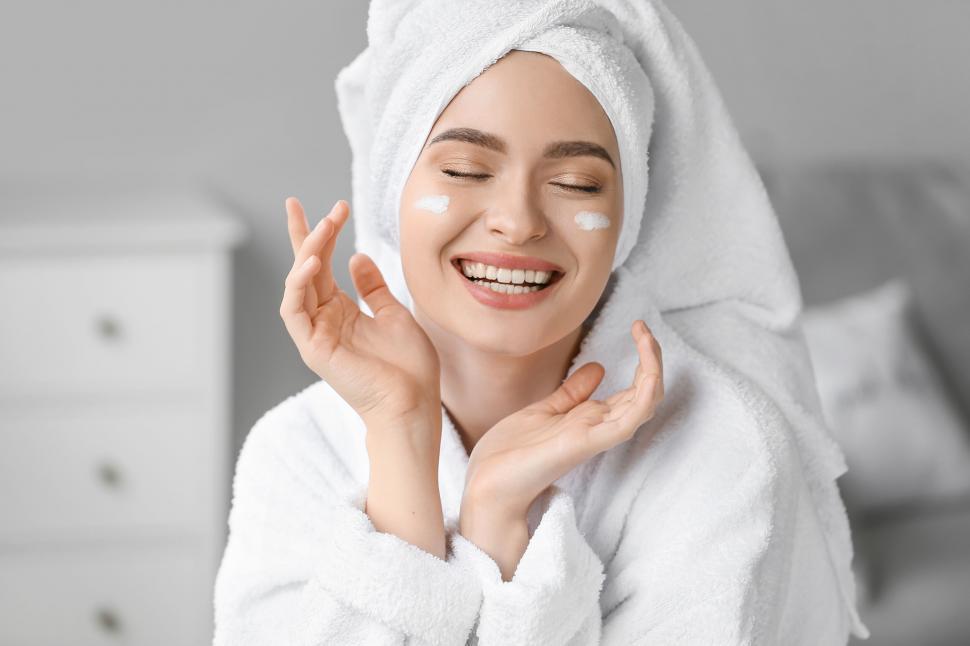 Free Image of A woman in a bathrobe and a towel on her head 