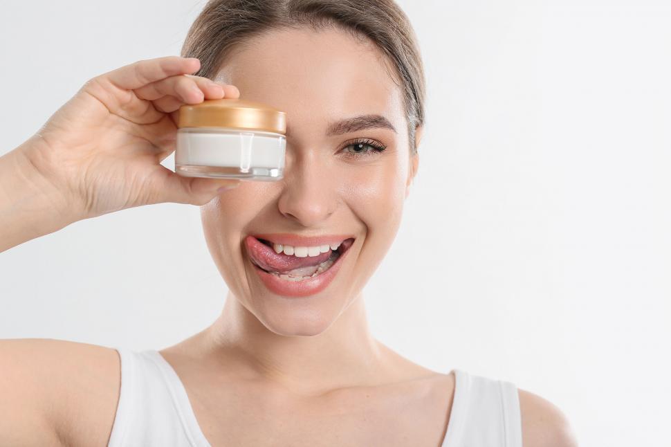 Free Image of A woman holding a jar of cream 