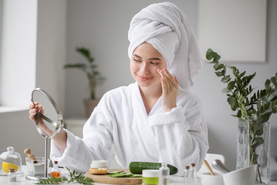 Free Image of A woman in a white robe and towel on her head 