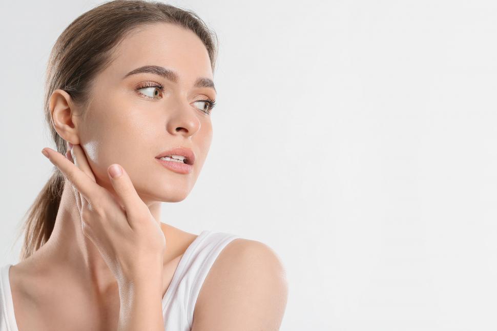 Free Image of A woman touching her face 