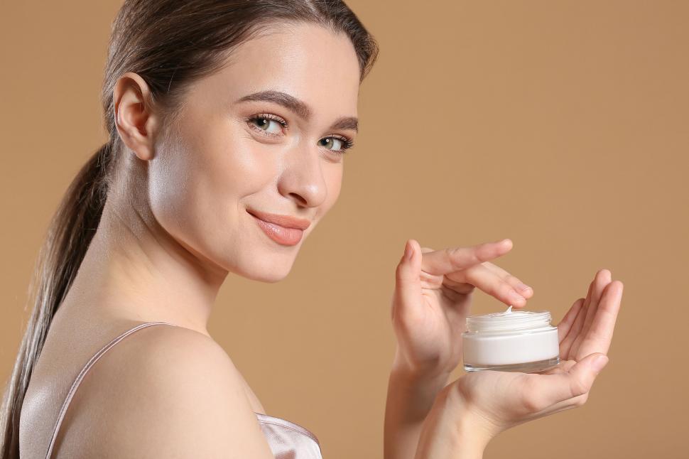 Free Image of A woman holding a jar of cream 
