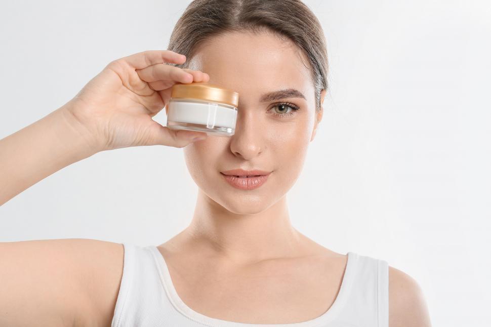 Free Image of A woman holding a jar of cream 