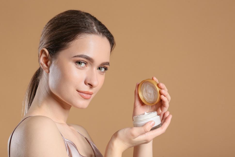Free Image of A woman holding a jar of cream 