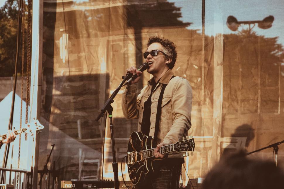 Free Image of A man singing into a microphone 