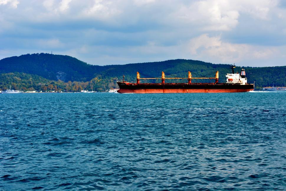 Free Image of Cargo ship sailing on a calm sea 