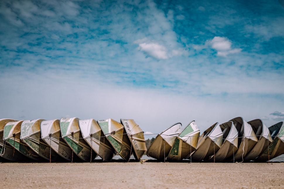 Free Image of Row of upside-down boats on a shore 