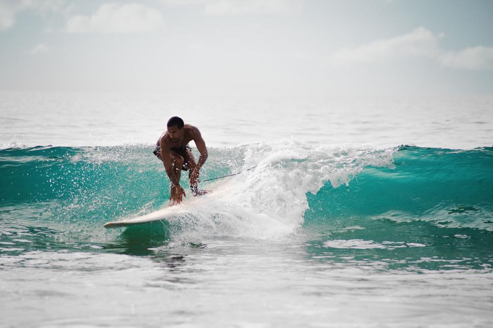 Free Image of Surfer riding a wave in the open sea 