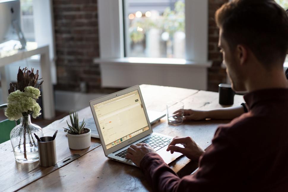 Free Image of Man working on laptop in home office setting 