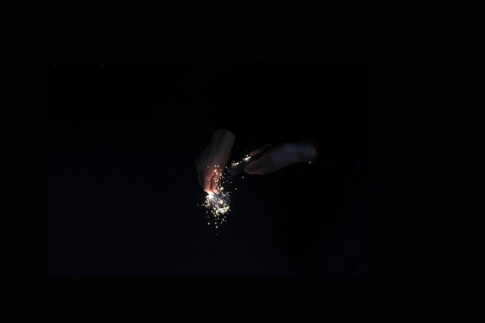 Free Image of Sparkler illuminating darkness with bright sparks 
