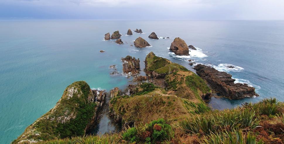 Free Image of Cliffside view with jagged rocks and ocean 