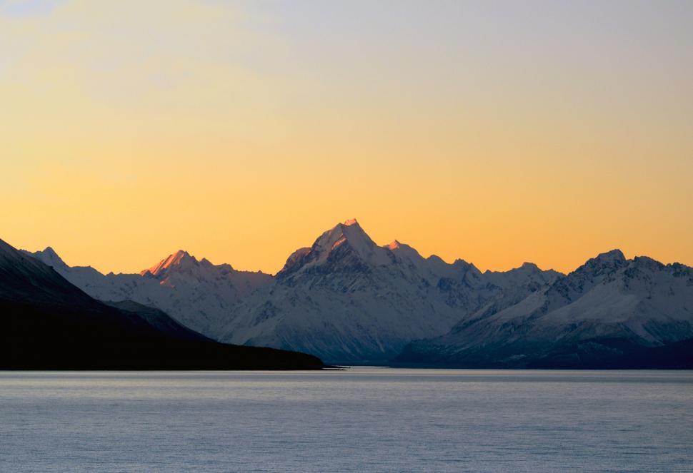 Free Image of Sunset glow on snowy mountain peaks 