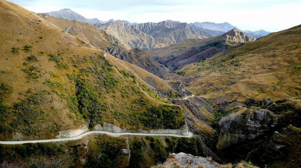 Free Image of Rugged mountain road winding through valley 