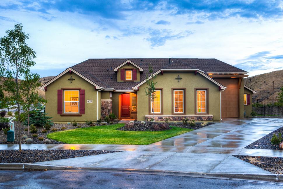 Free Image of Modern house with lush landscaping at dusk 
