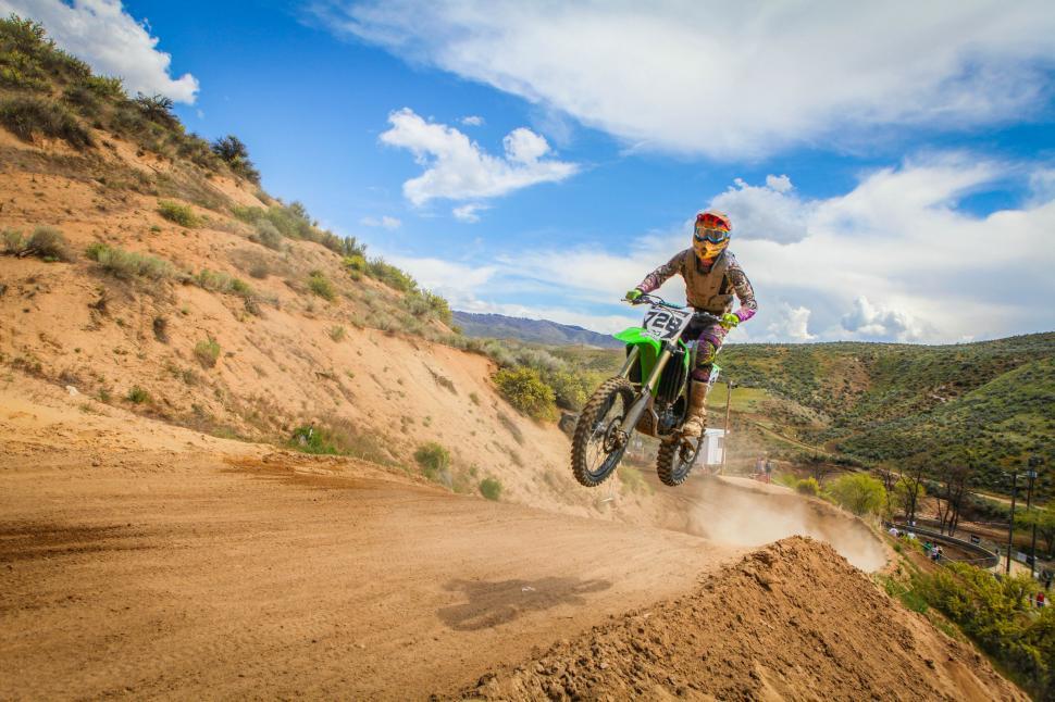 Free Image of Motocross rider taking a jump in a race 