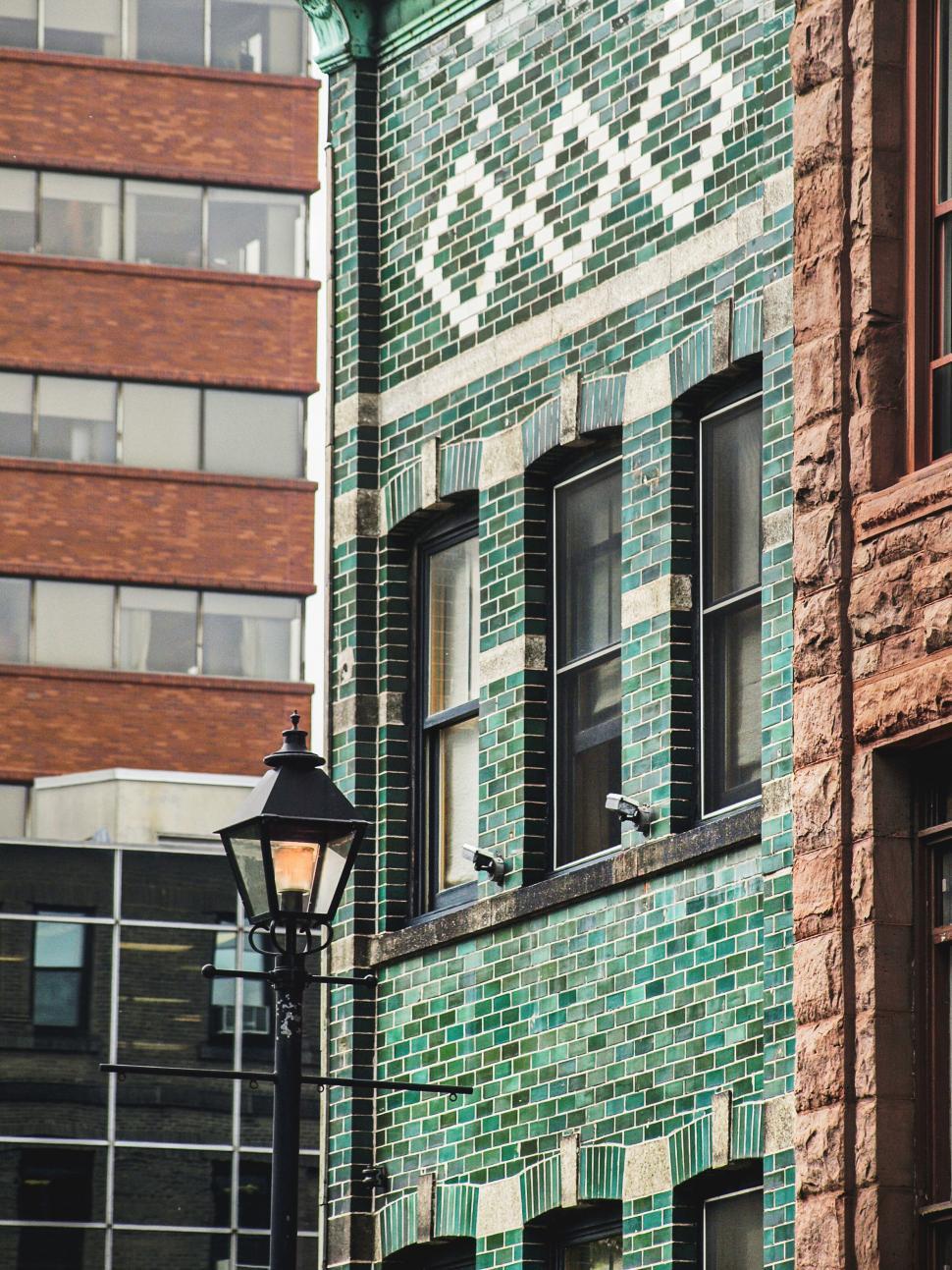 Free Image of Old brick building with green tile facade 