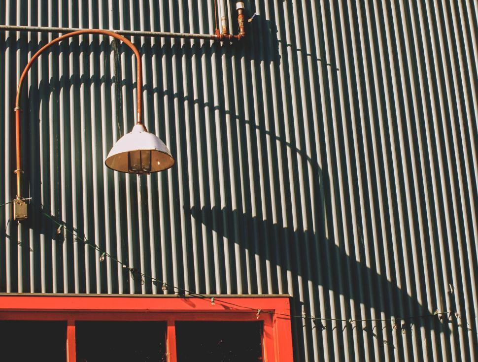 Free Image of Architectural shadow casting on corrugated facade 