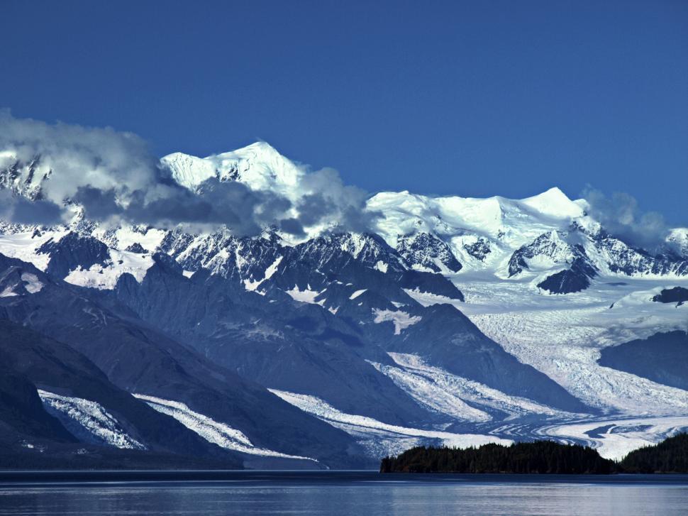 Free Image of Snow-capped mountains by a lake 