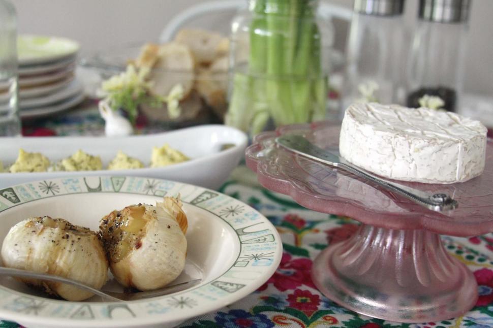 Free Image of Rustic cheese platter on a colorful tablecloth 