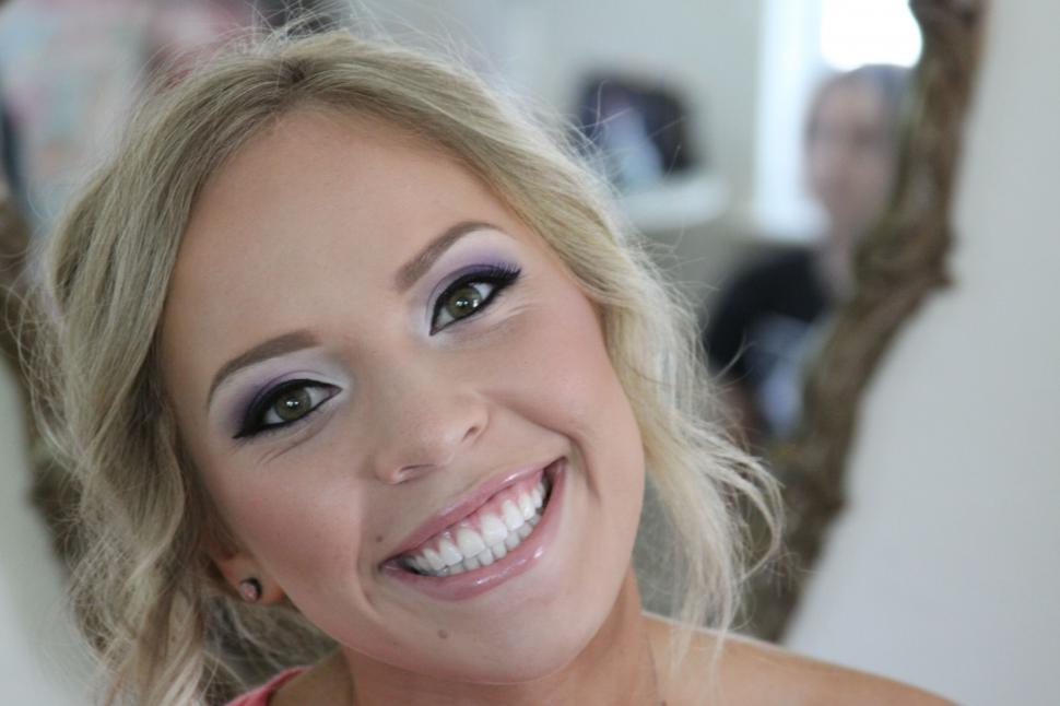 Free Image of Smiling woman with makeup looking at camera 
