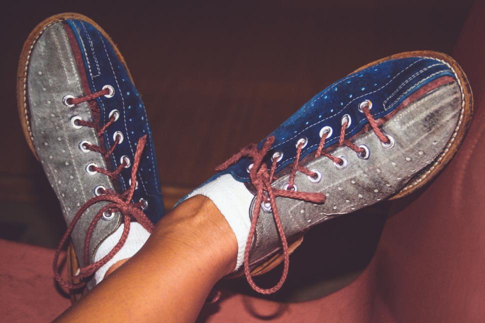Free Image of Feet up in colorful sneakers against wall 