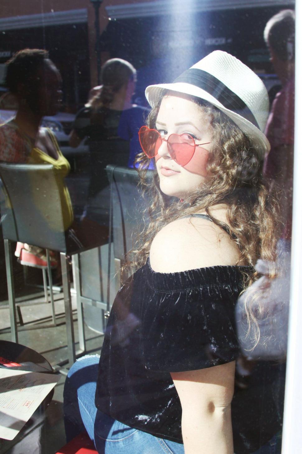 Free Image of Woman Observing People from Behind Window 