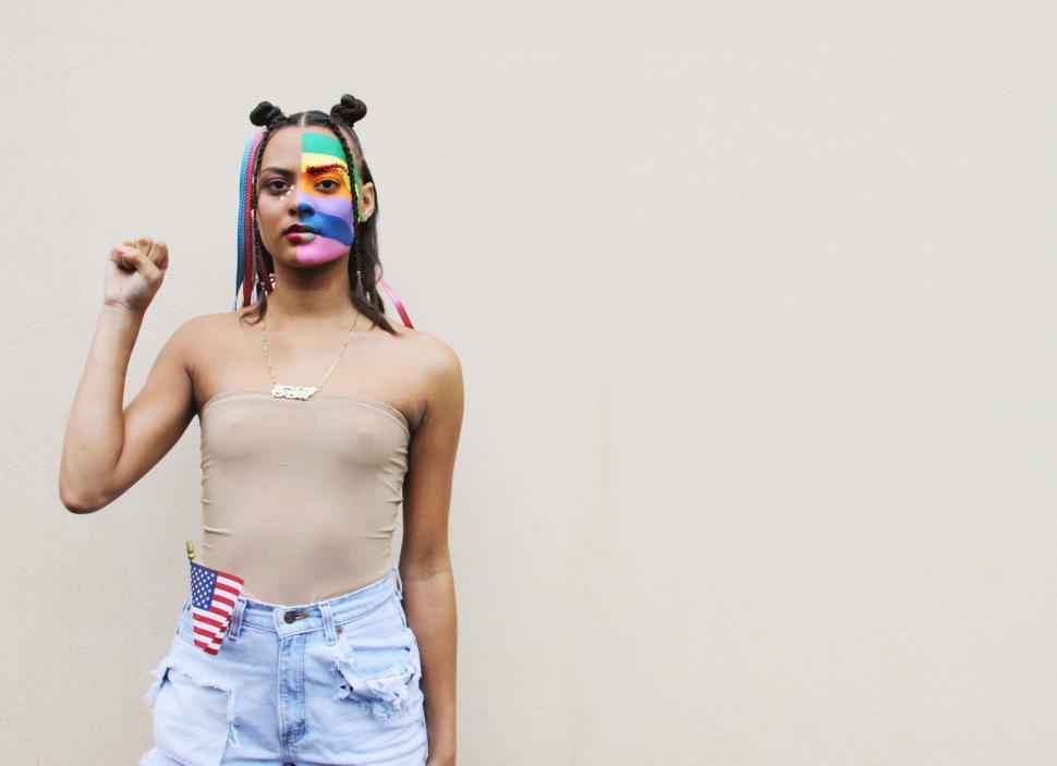 Free Image of Woman with colorful face paint posing 