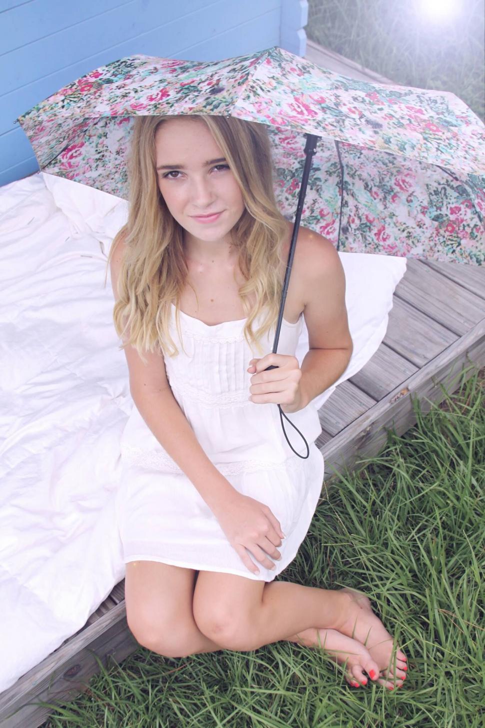 Free Image of Girl with umbrella on grassy field 