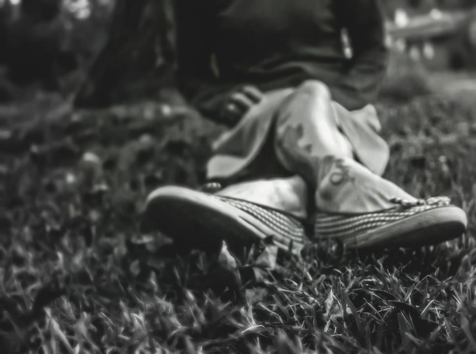 Free Image of Close-up of worn sneakers on grass 