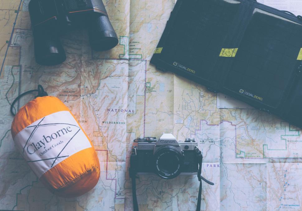 Free Image of Adventure travel gear spread on a map 
