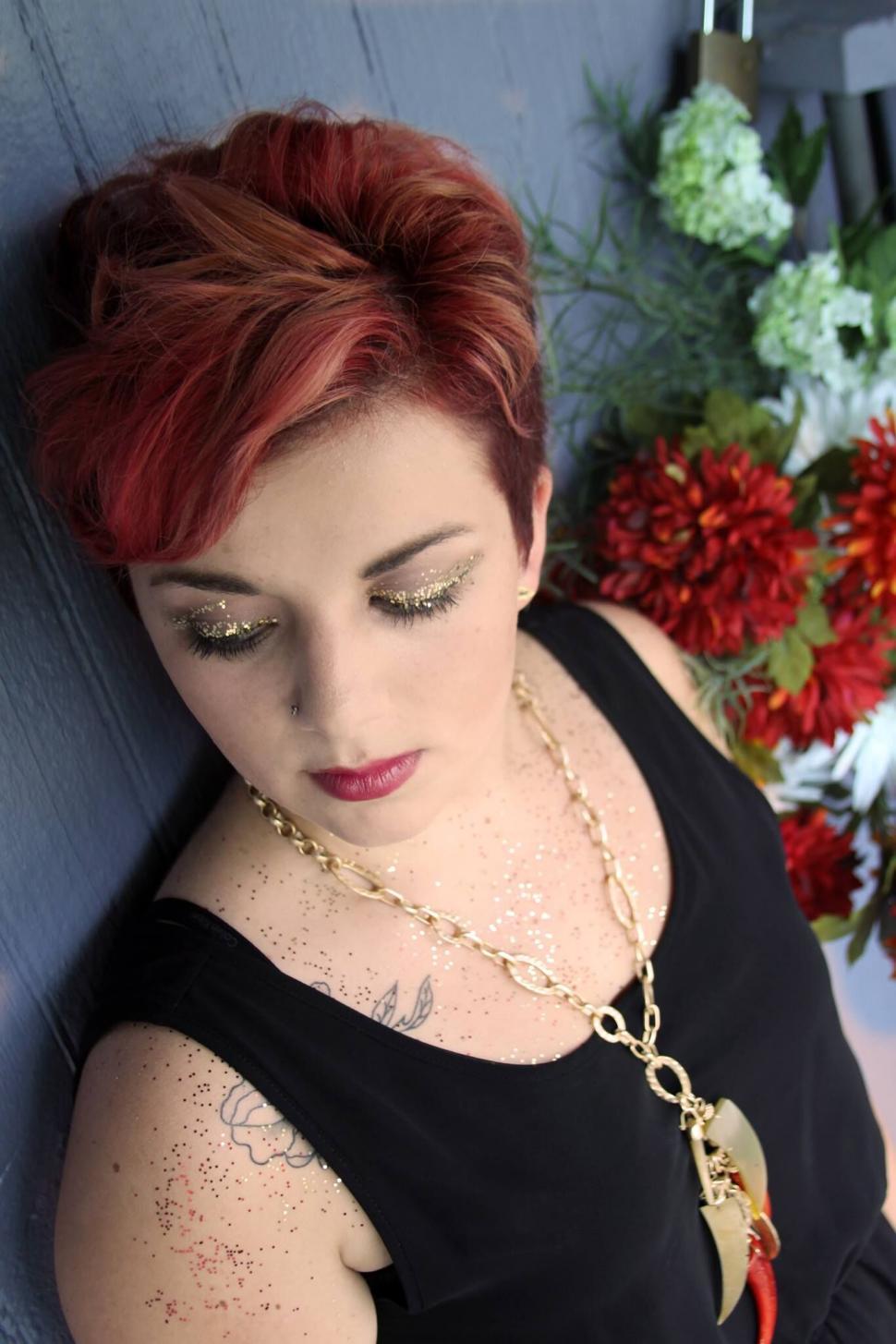 Free Image of Woman lying down with autumnal flowers 