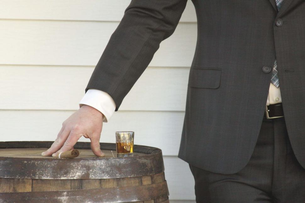 Free Image of Man resting hand on a whiskey glass 