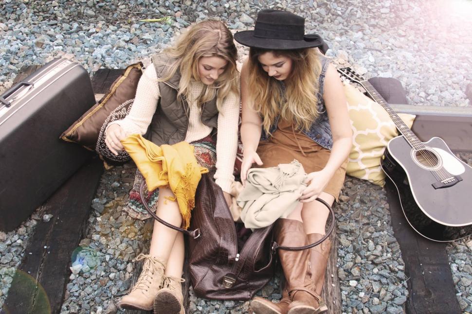 Free Image of Two friends with guitar on rocky ground 