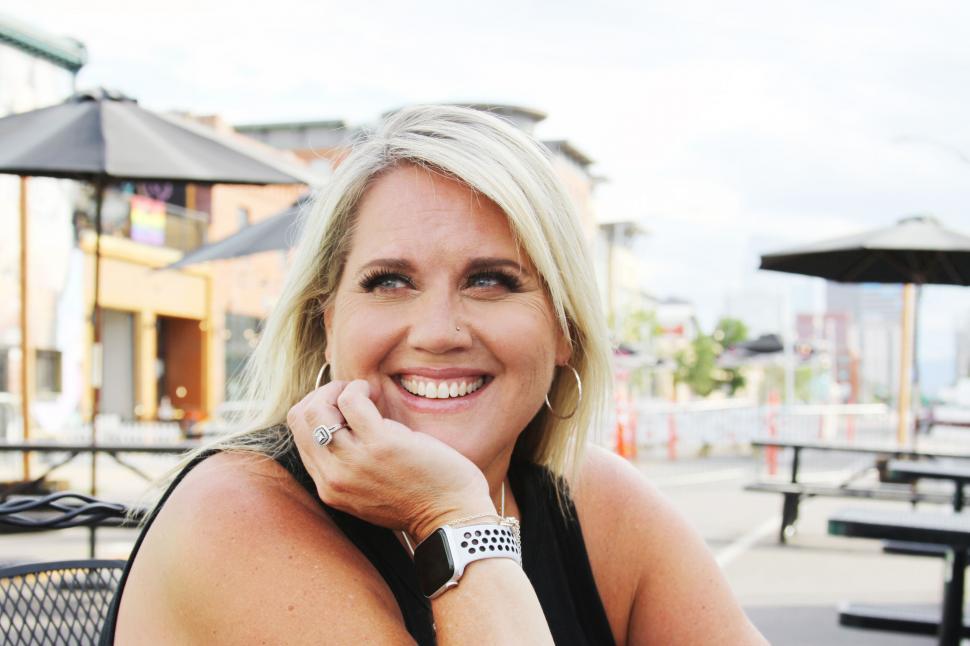 Free Image of Smiling woman outdoors with urban background 