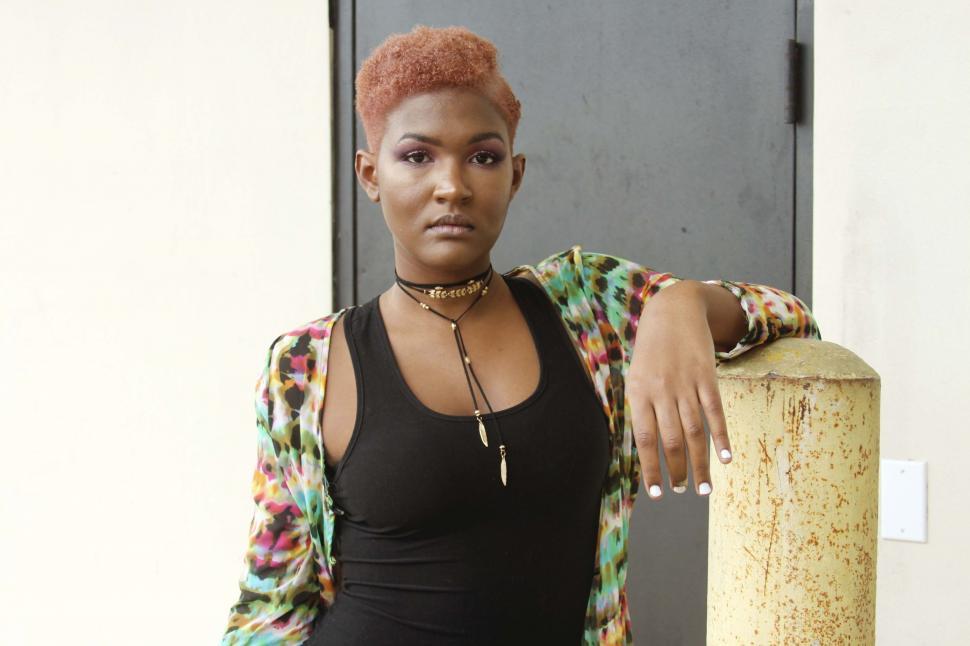 Free Image of Fashionable woman posing near a pillar 