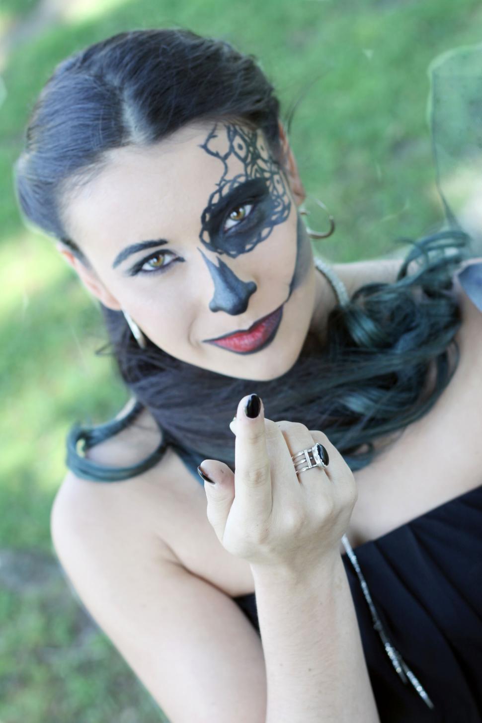 Free Image of Woman with face paint posing with mystique 