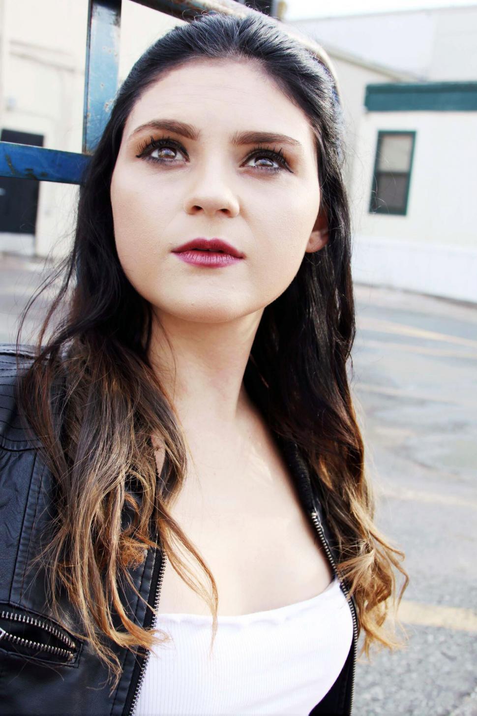 Free Image of Woman with leather jacket gazing up 