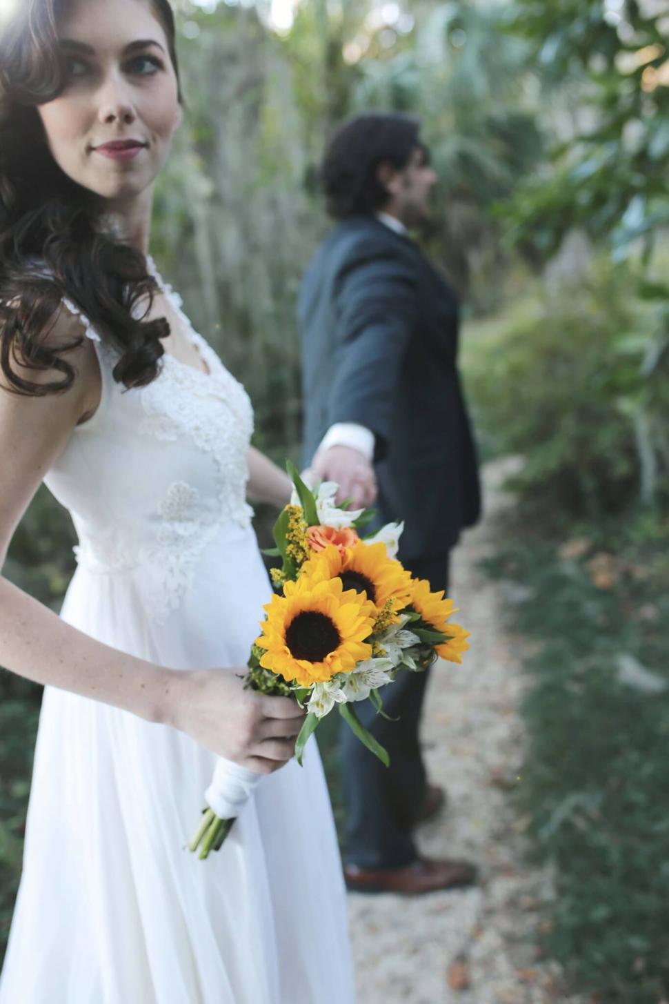 Free Image of Bride and groom holding hands 