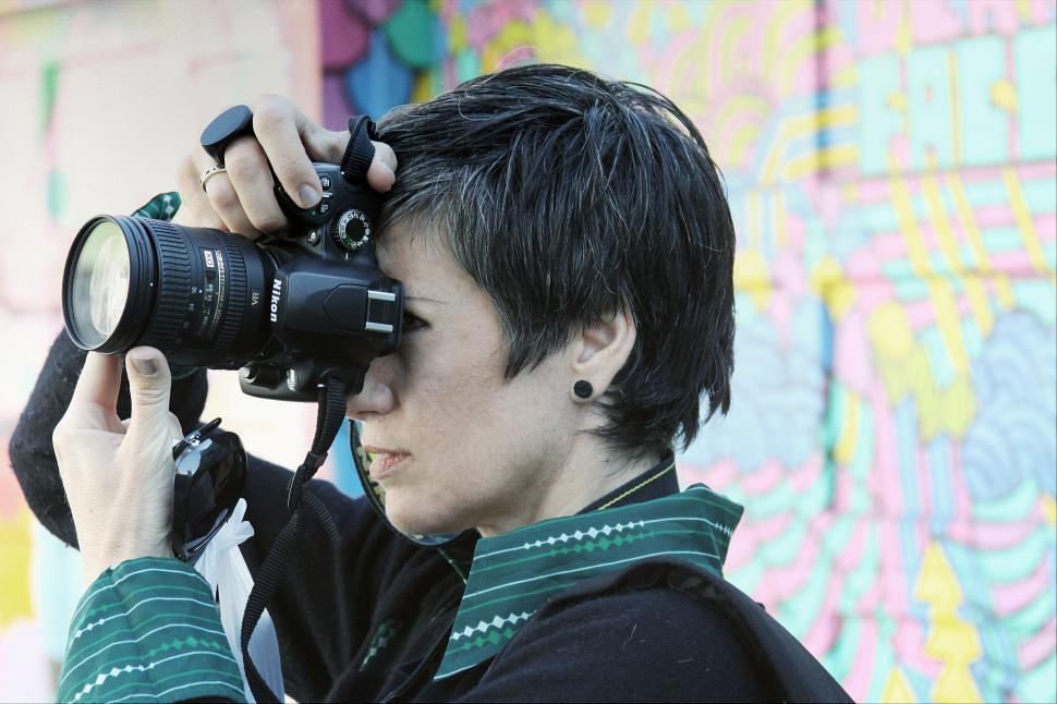Free Image of Photographer capturing graffiti wall 