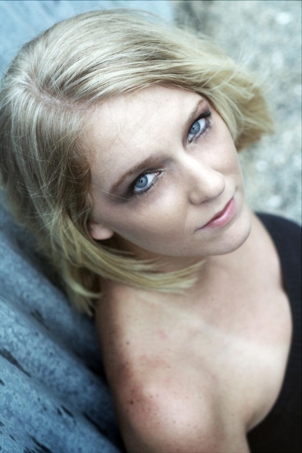 Free Image of Woman lying down on a rock surface 