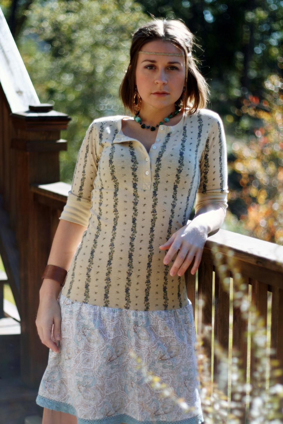 Free Image of Casual woman in sunlight with fall backdrop 