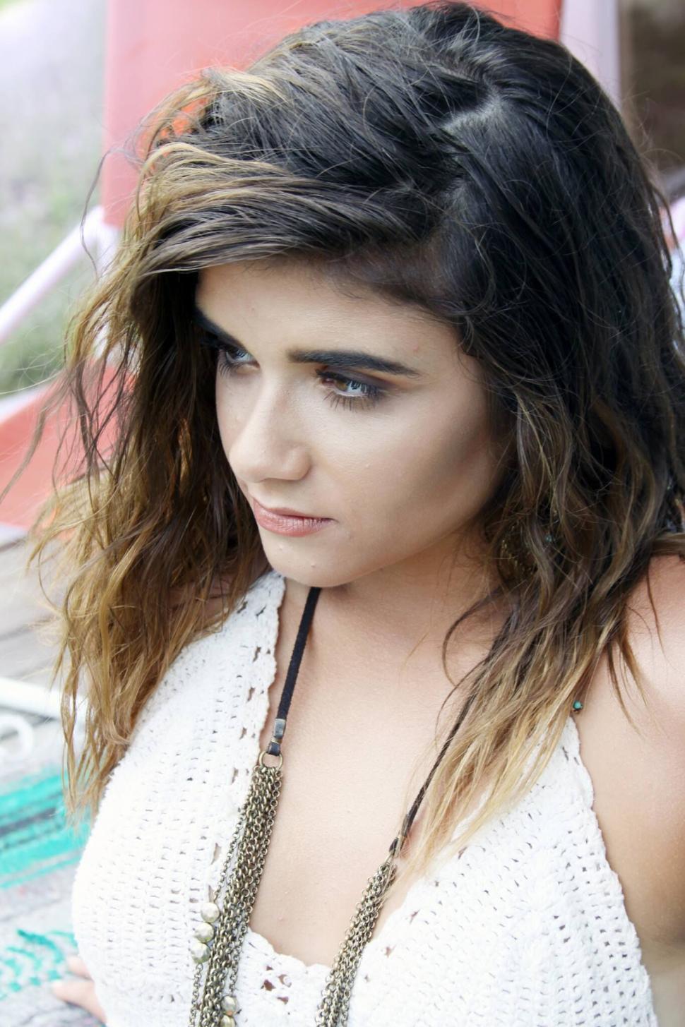 Free Image of Thoughtful woman with tousled hair close-up 